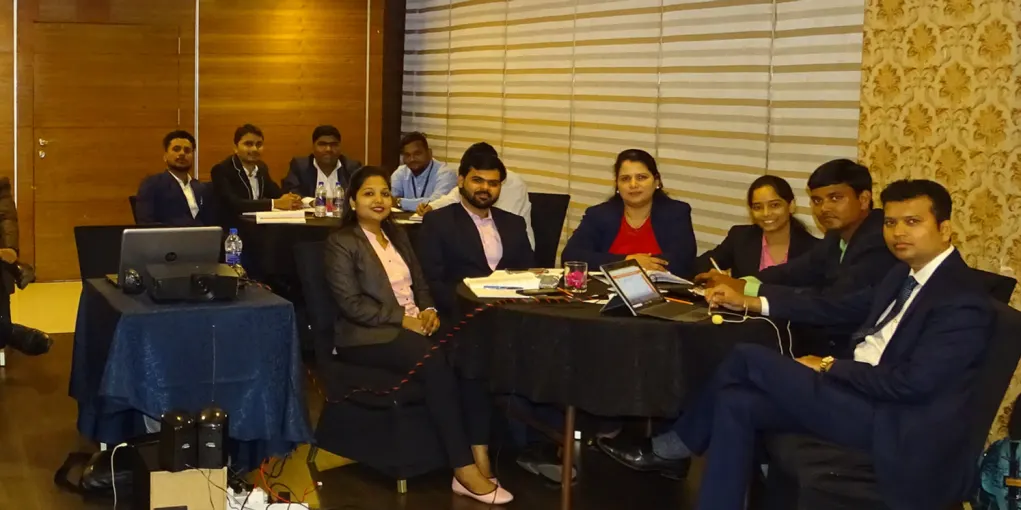 ORNET staff seated at tables during an internal training session
